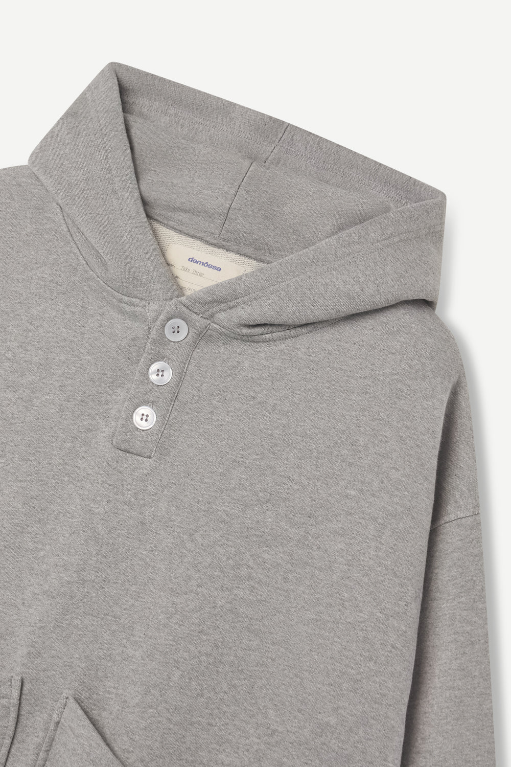 Light gray hoodie with button details on a white background