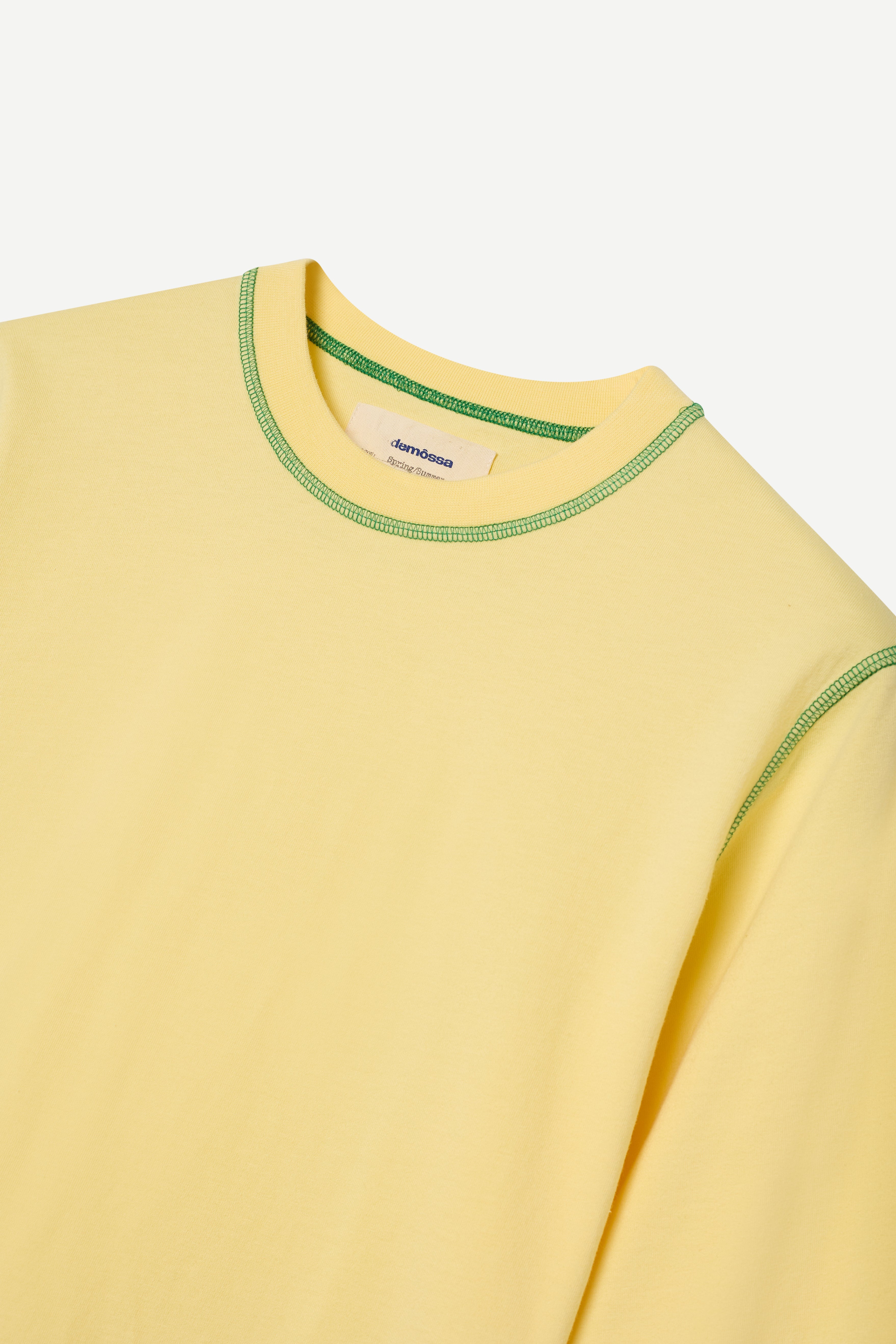Yellow long-sleeve shirt with green trim on a white background