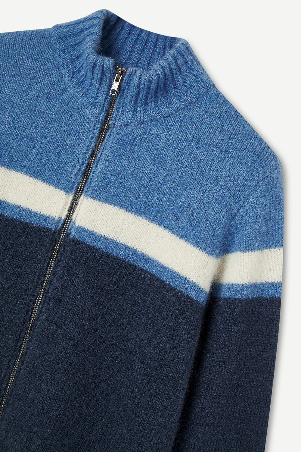 Blue and navy color-blocked sweater with a zipper on a light gray background