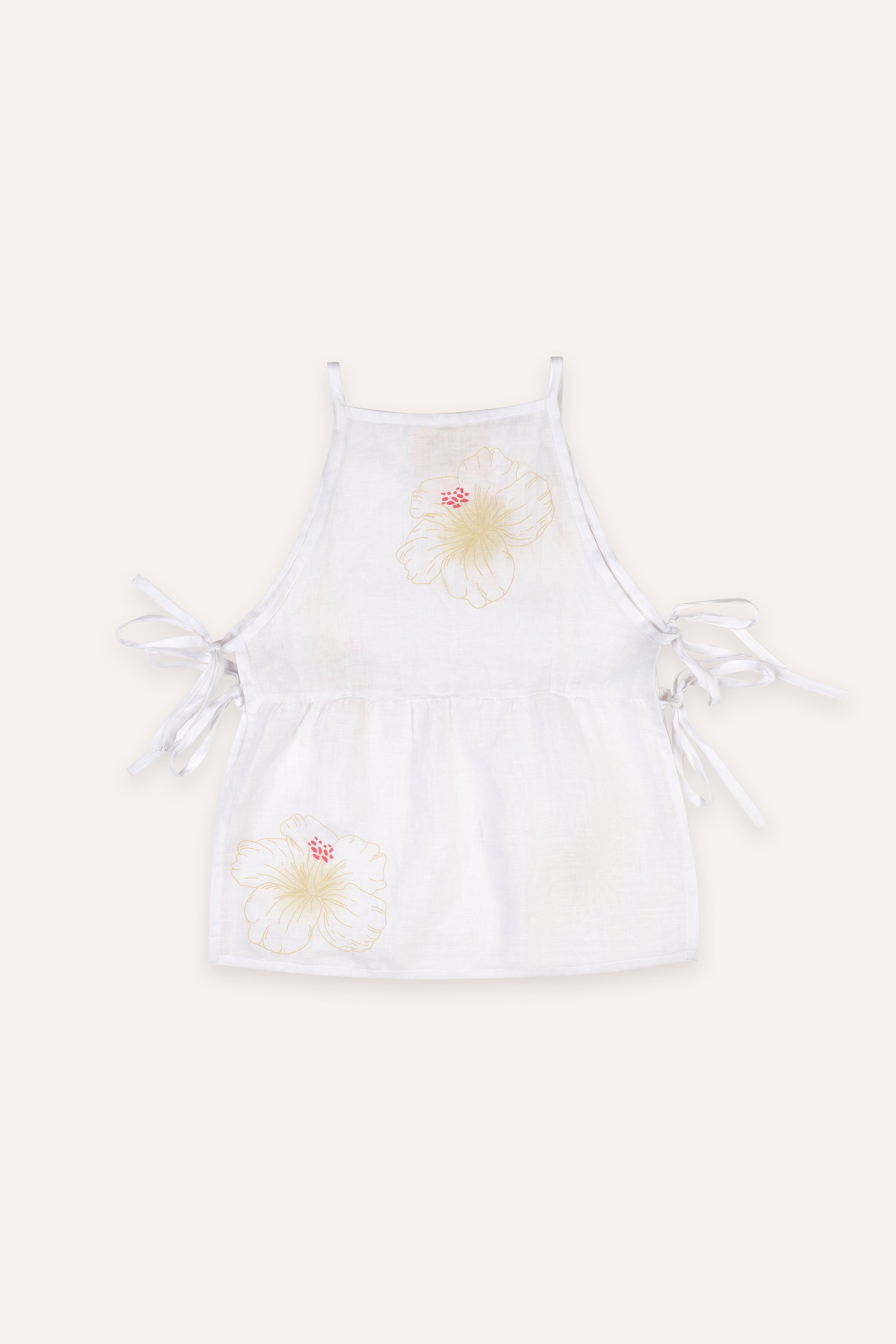 White top with floral designs on a white background