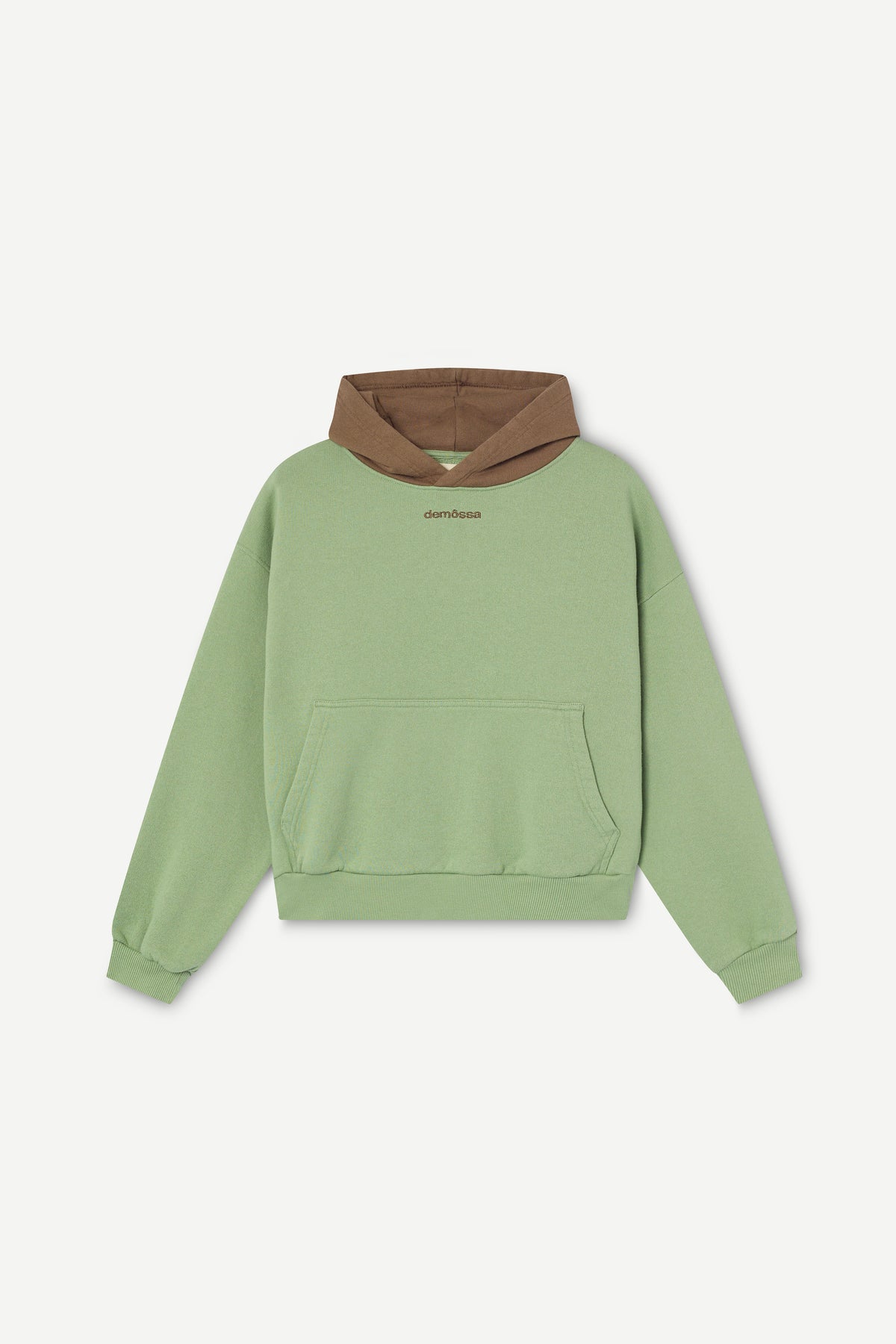 A sage green cropped hoodie with a contrasting brown hood lining and a small brown logo on the chest, displayed against a light gray background.