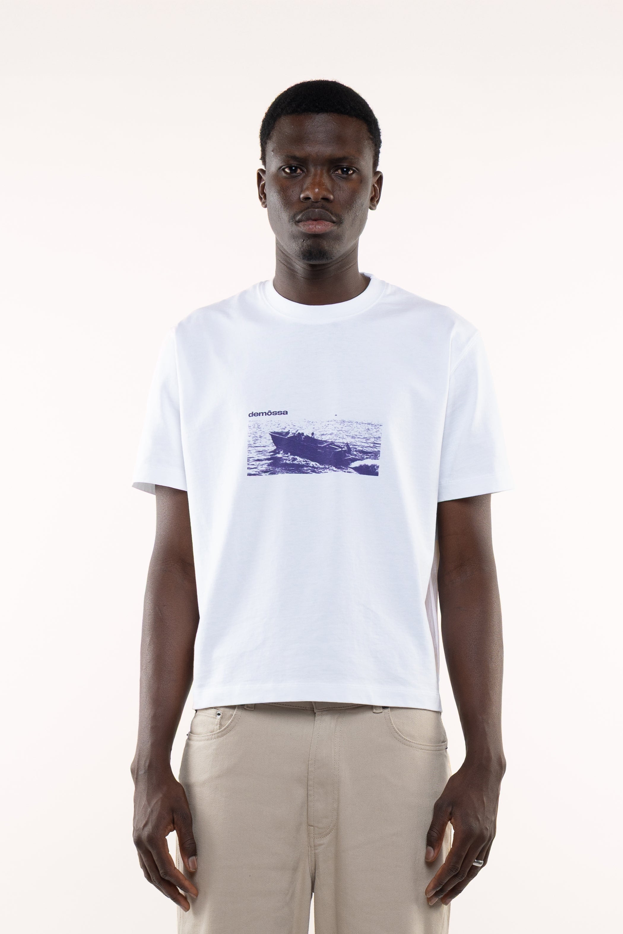 Front view of men’s white T-shirt with vintage speedboat print and small Demossa logo