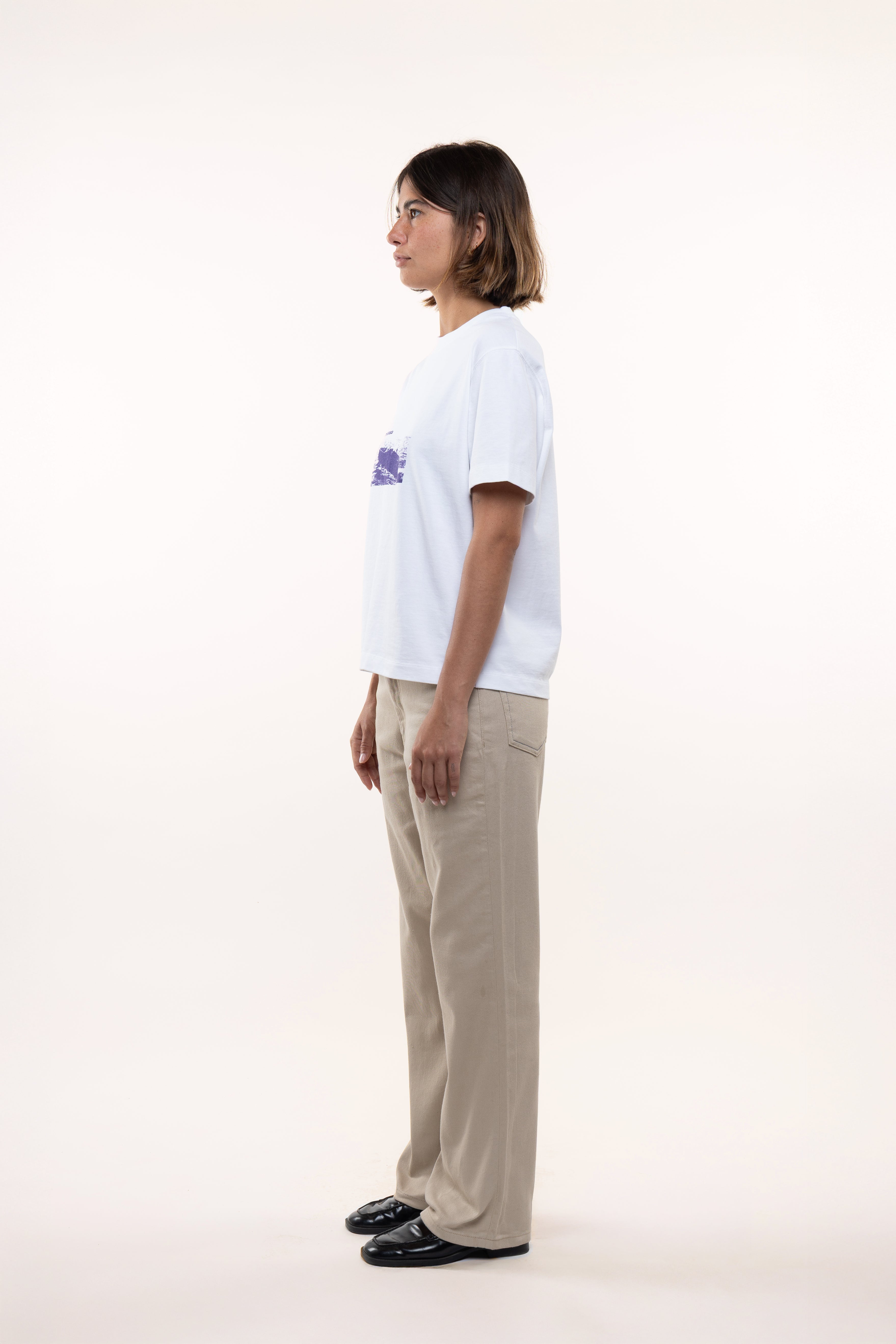 Side profile of women’s white T-shirt with short sleeves and visible boat print detail