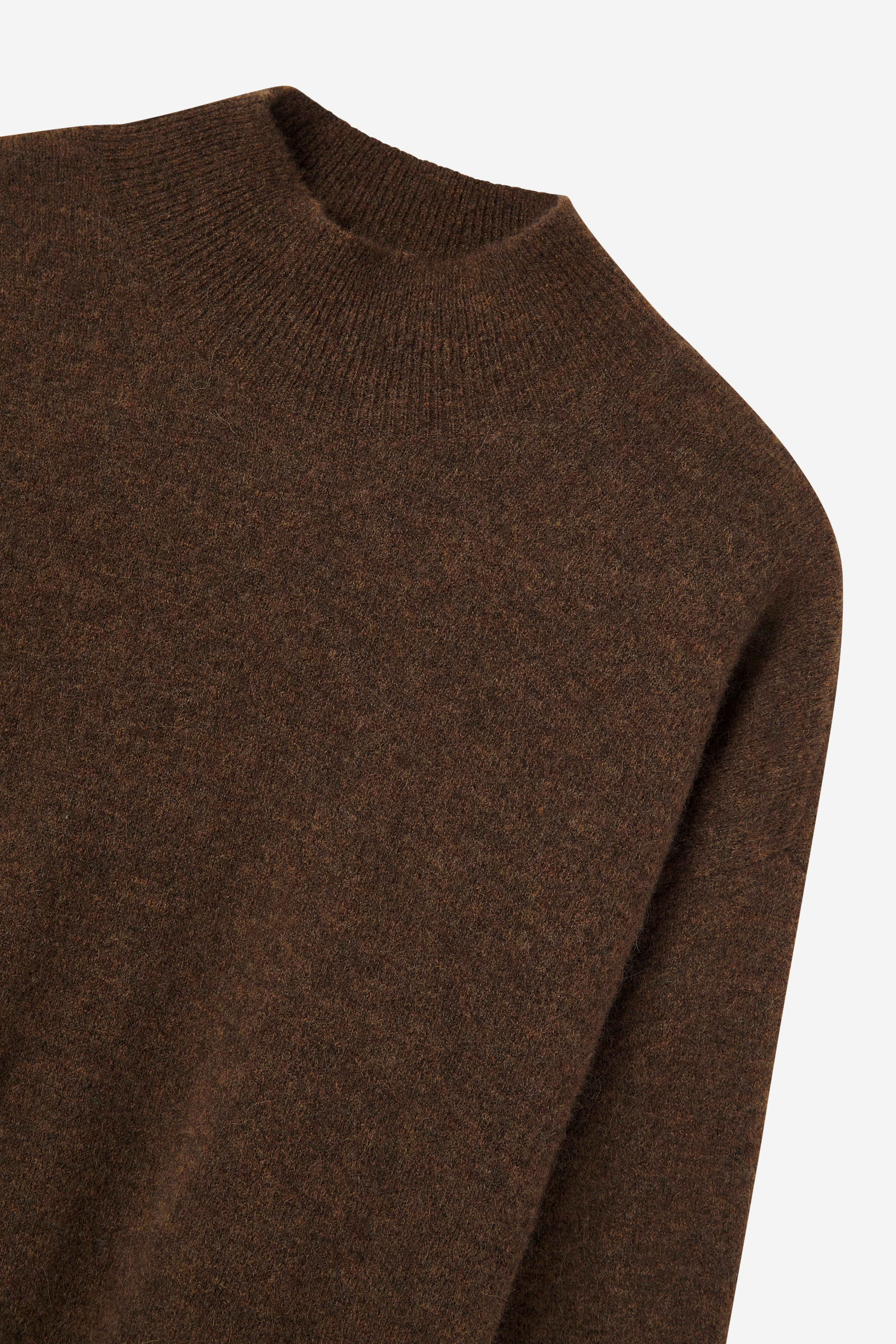Brown sweater on a light gray background