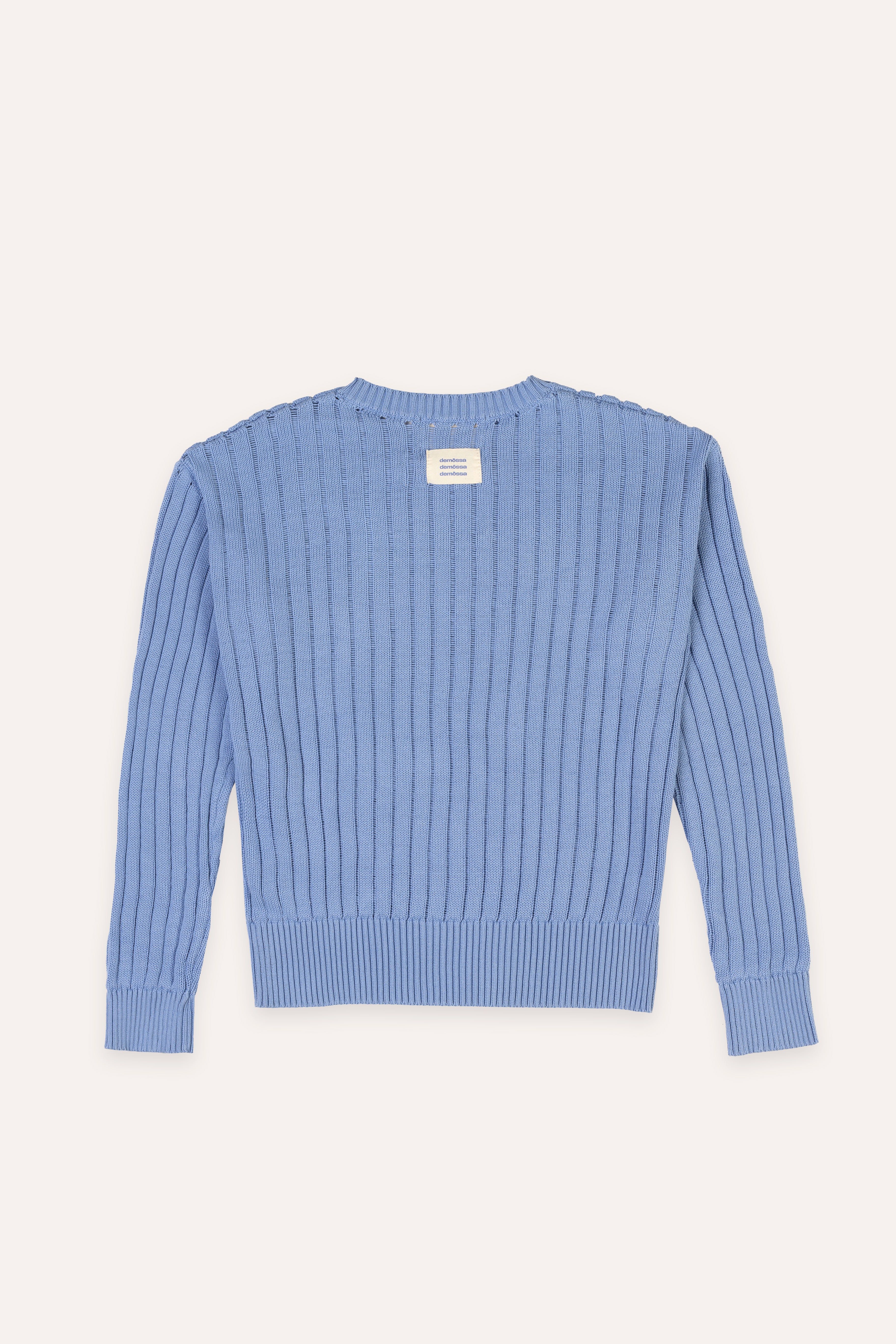 Blue ribbed sweater on a light gray background