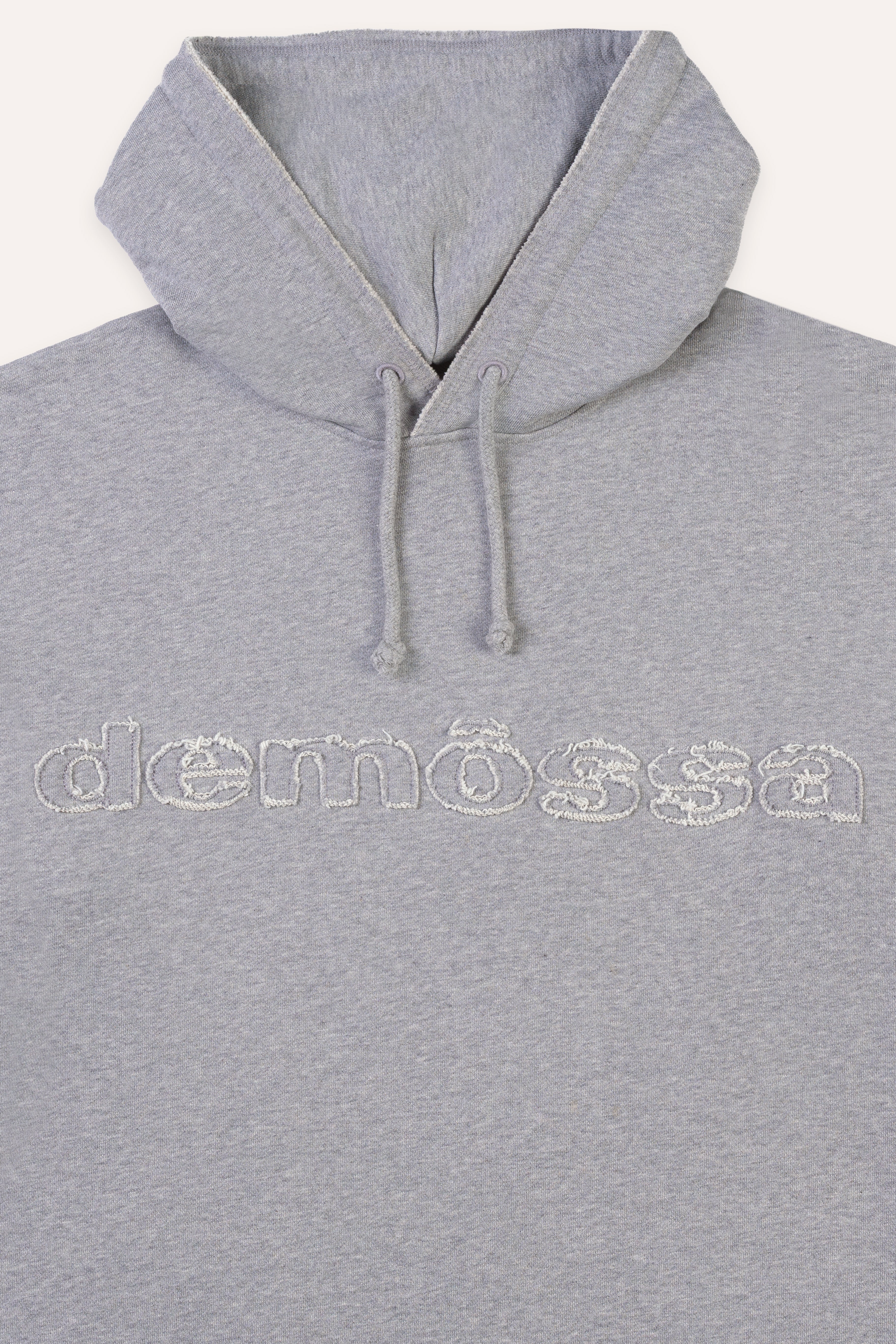 Gray hoodie with 'demossa' branding on a white background