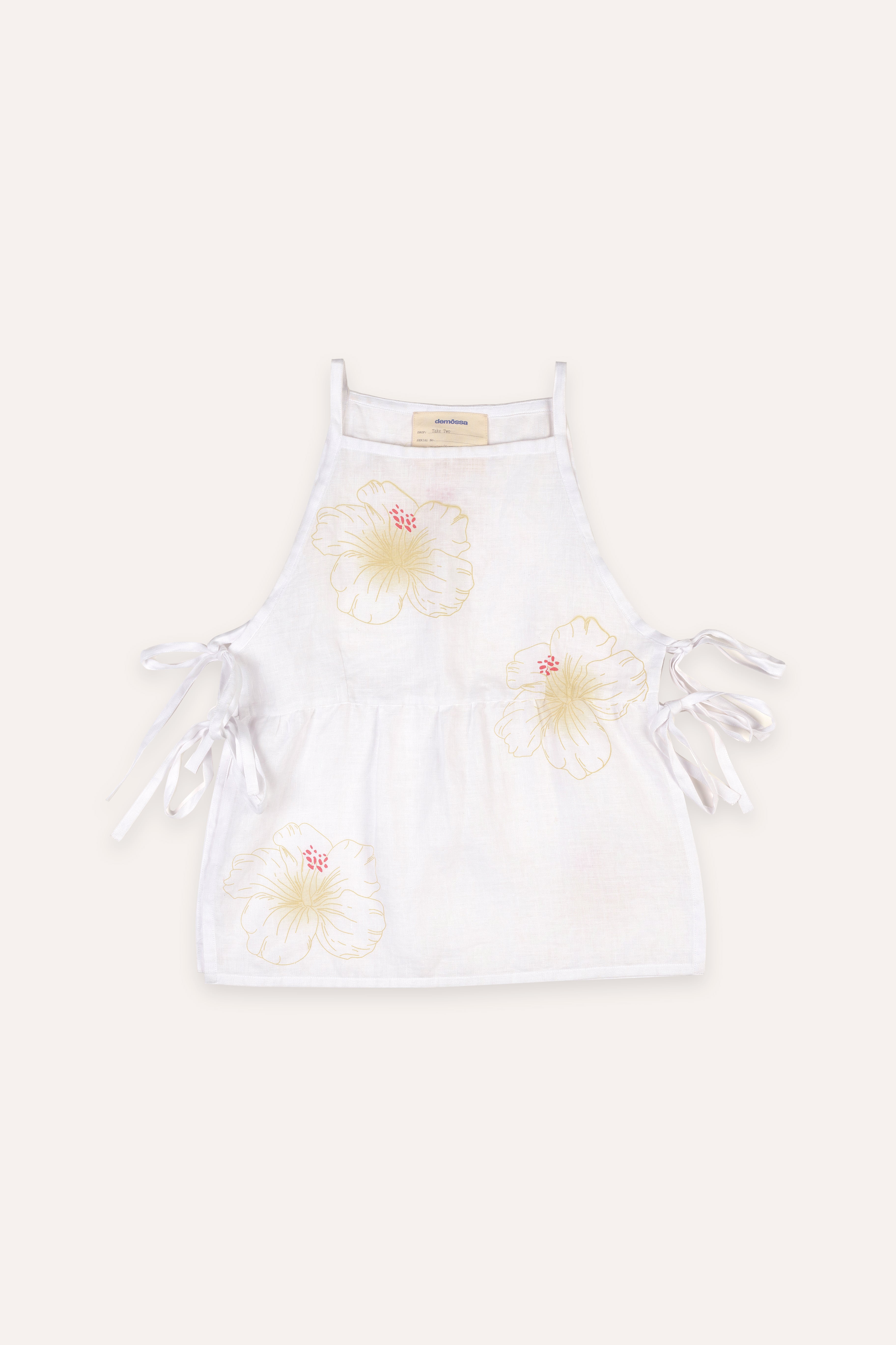 White top with floral designs on a white background