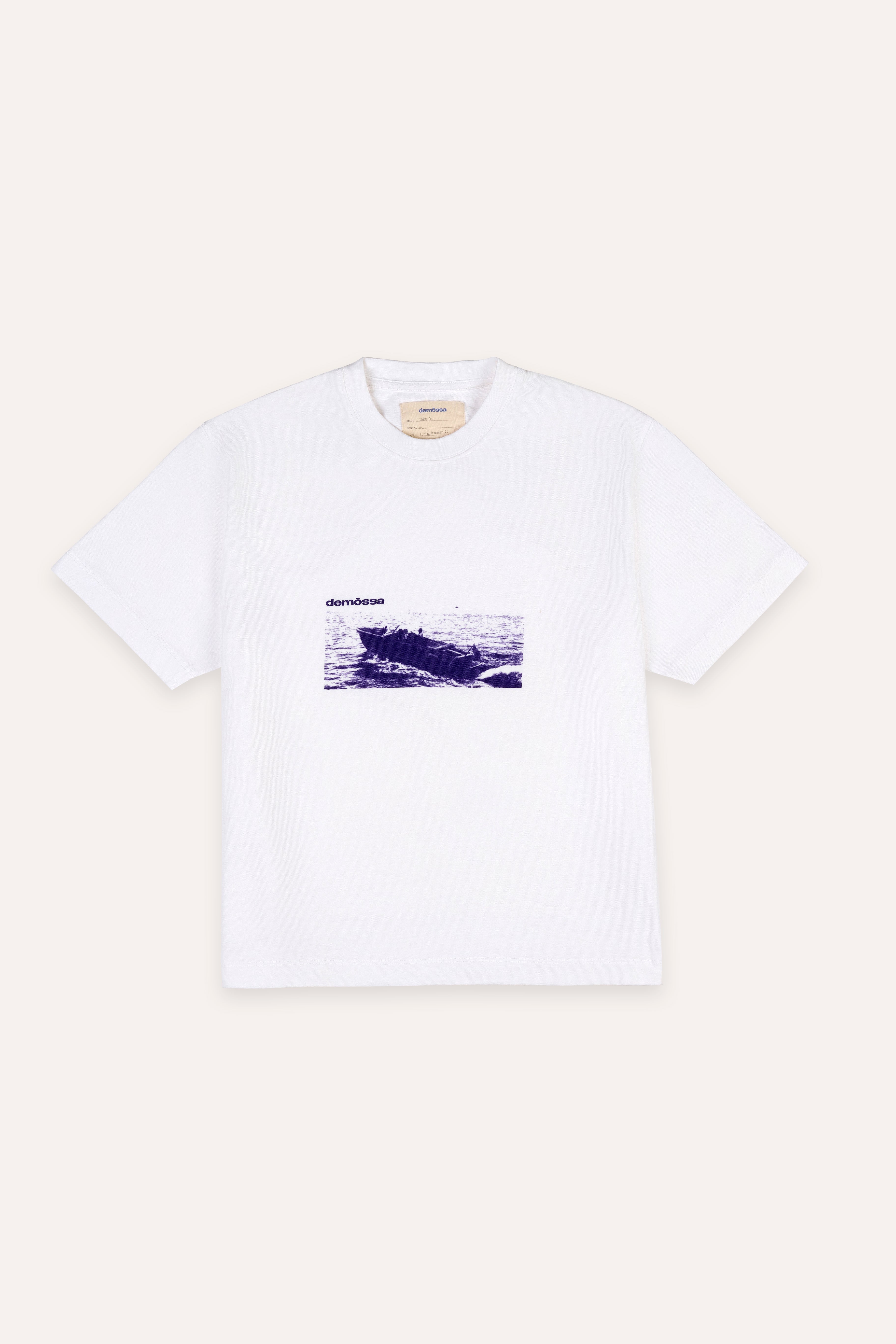 White t-shirt with a graphic design on a beige background