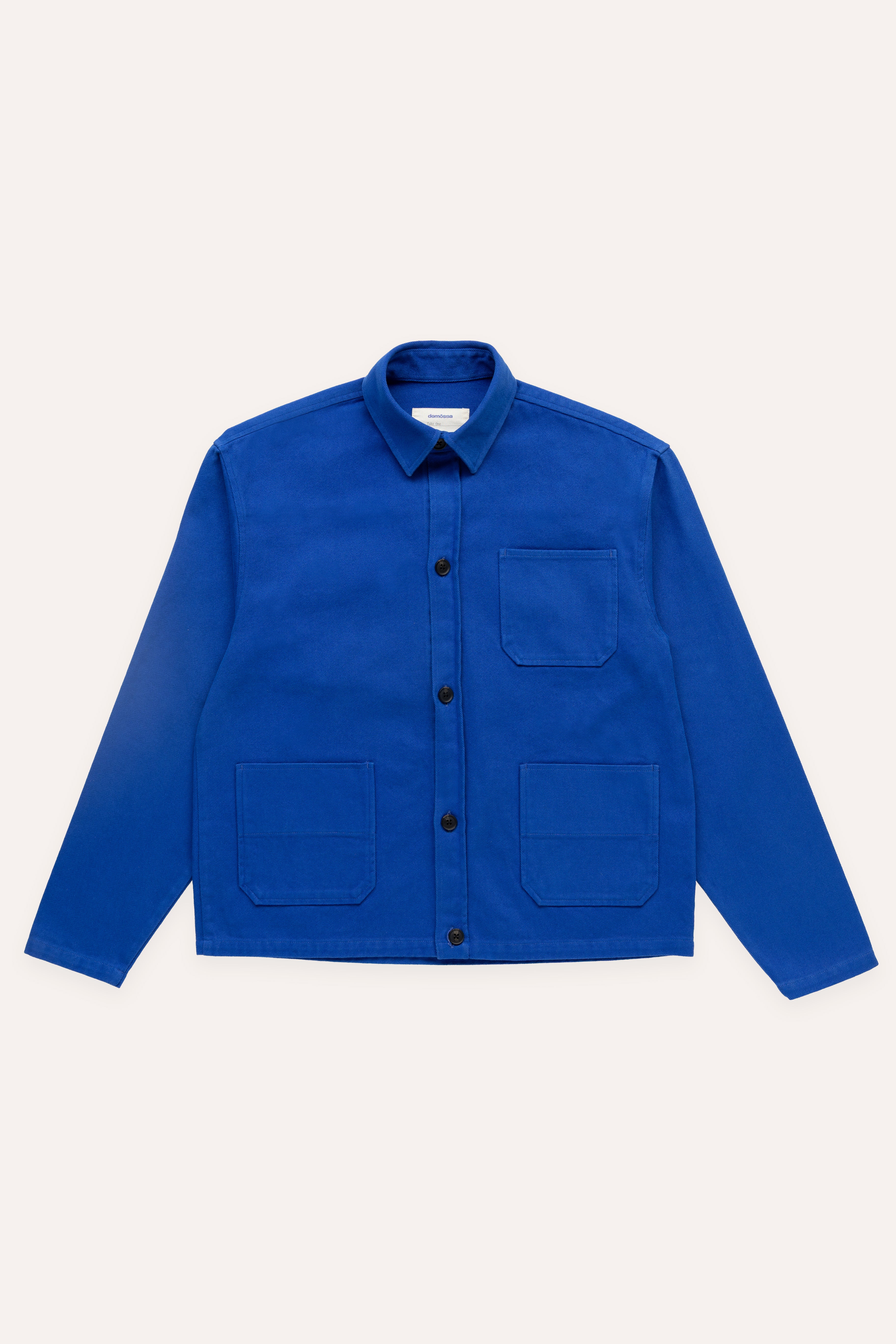 Flat lay of blue overshirt with three visible pockets and black front buttons