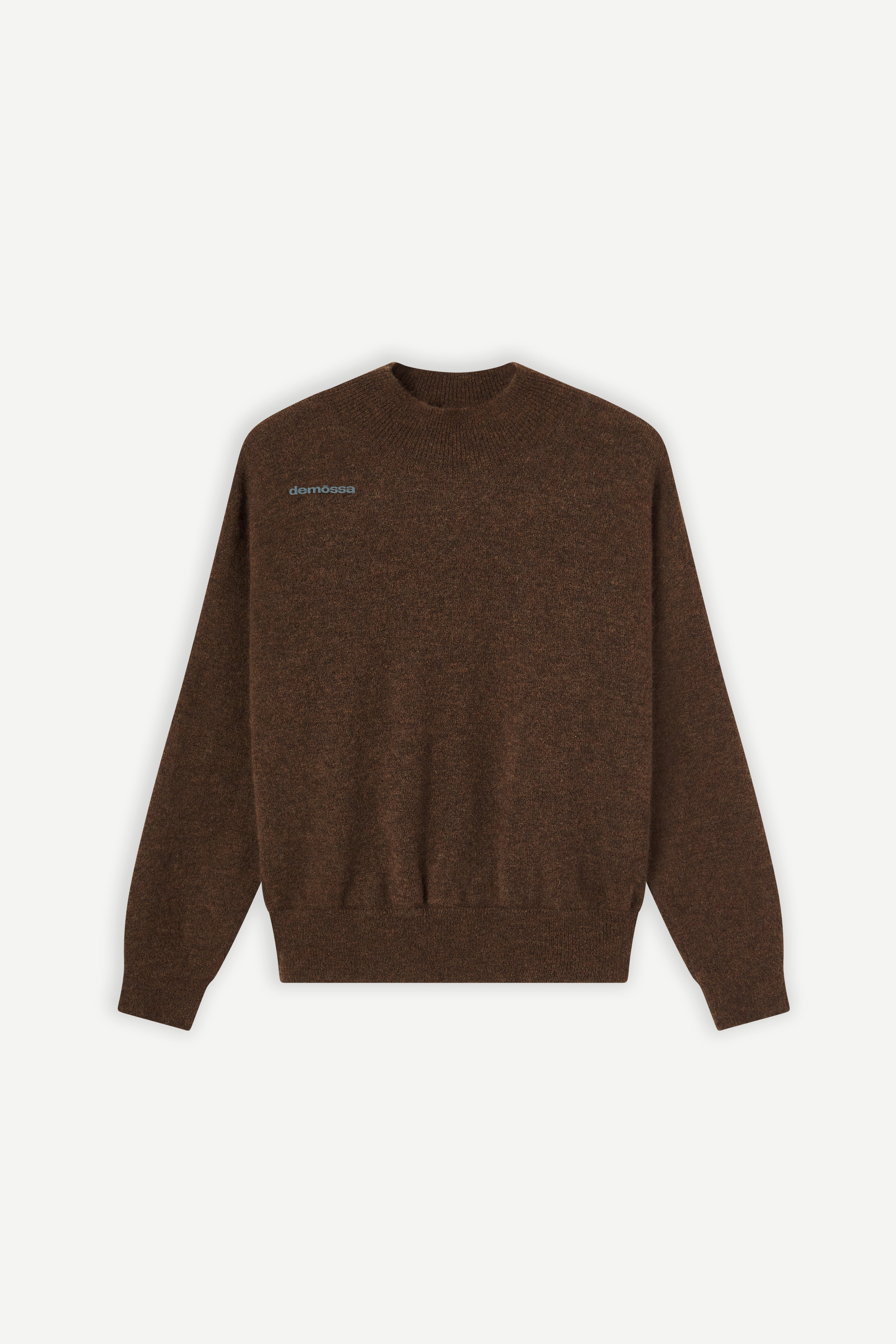 front view of a brown mockneck sweater with demossa embroidered on upper chest