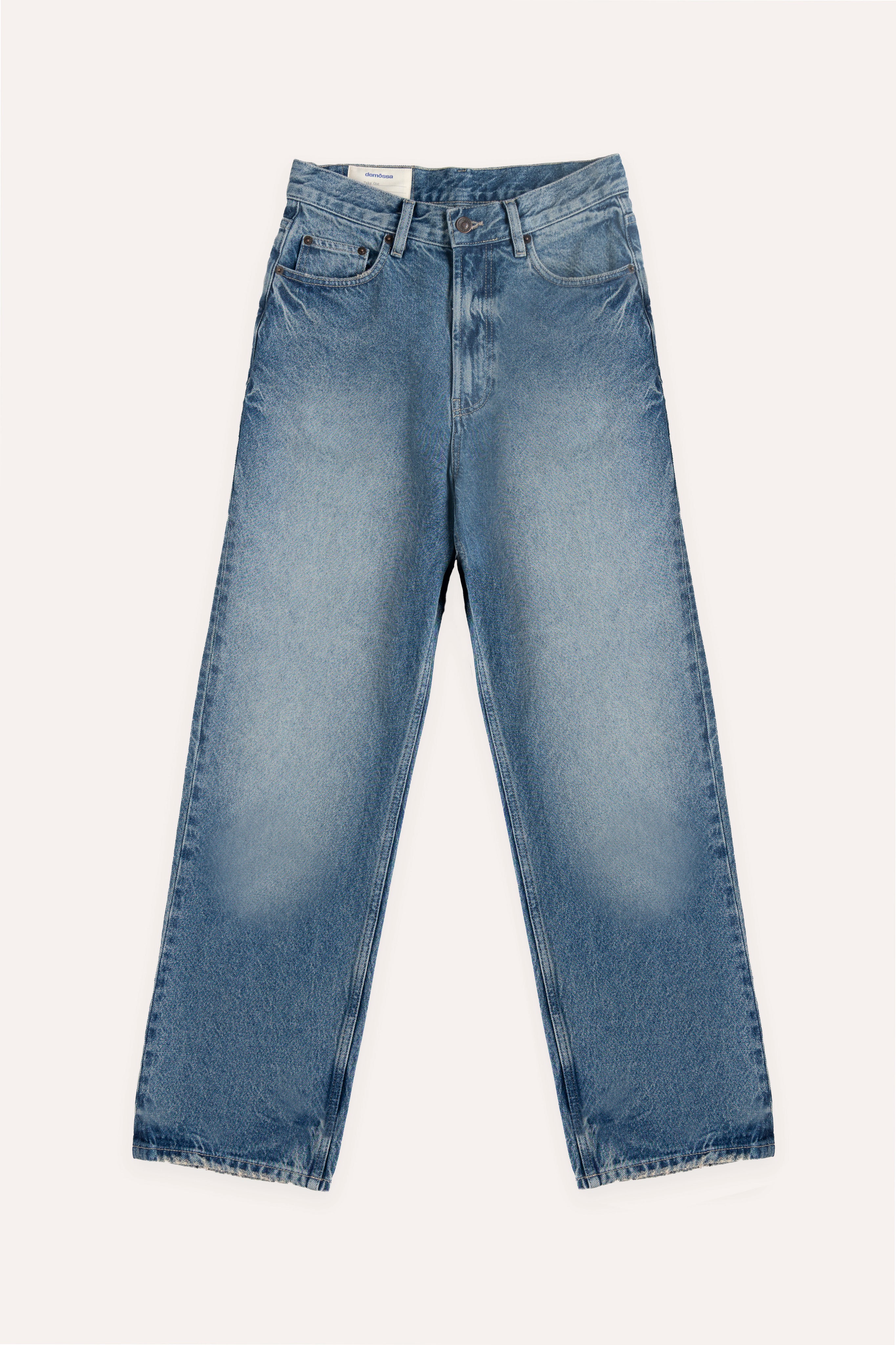 Flat lay of classic blue denim jeans with front button closure, five pockets and straight-leg fit