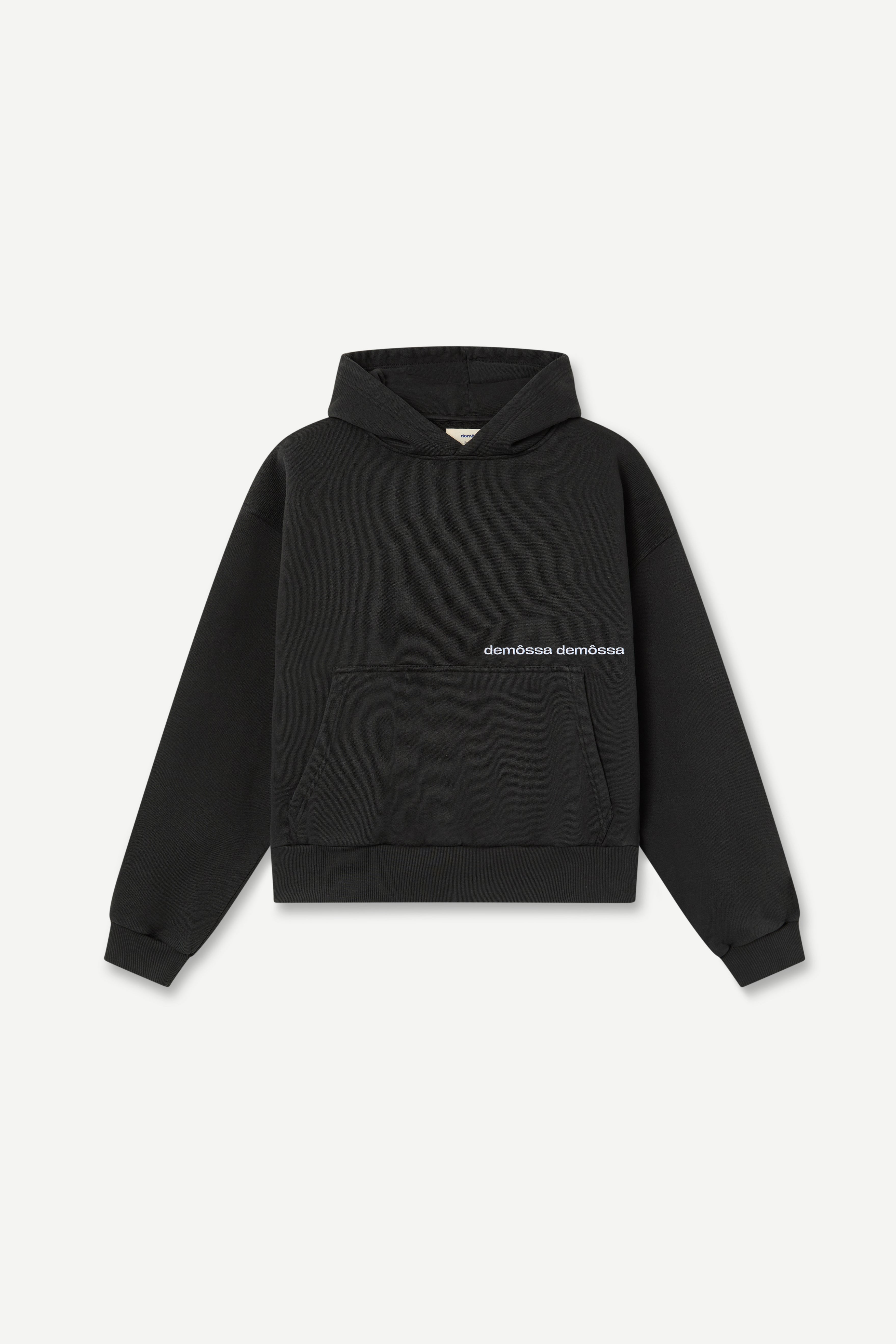 Black hoodie with brand demôssa logo on a light gray background
