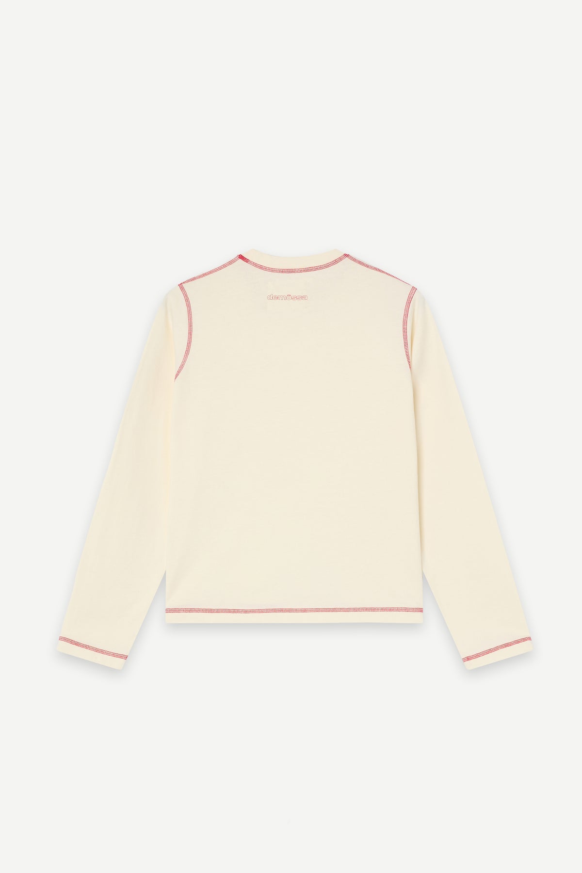 A cream-colored long-sleeve top with thin red piping details along the neckline, sleeve cuffs, and hem, displayed against a light gray background.